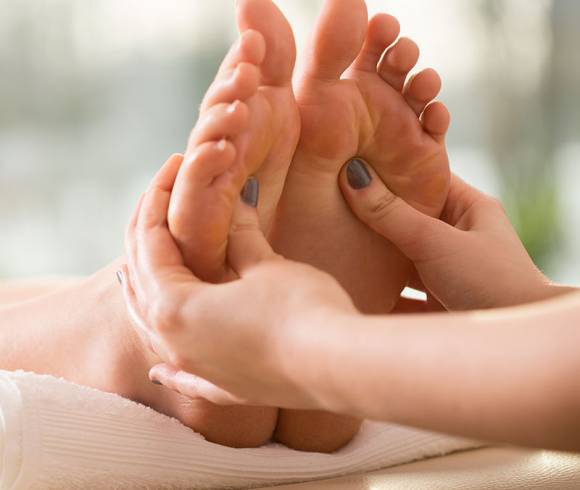 Foot massage with relaxing foot bath and pressure point technique to activate inner energy.
