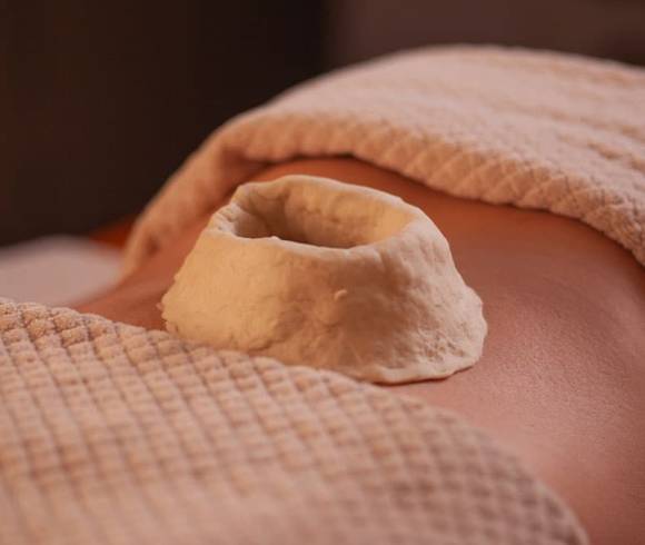 Ayurvedic dough ring for treating pain on the back.
