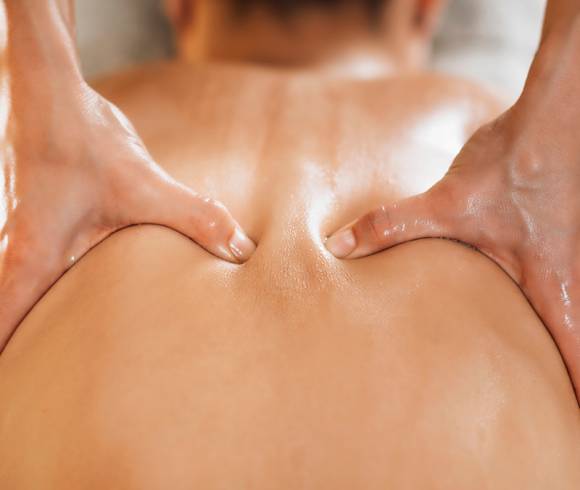 Ayurvedic back massage with warm oil to relieve tension and stimulate circulation.